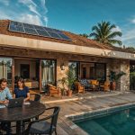 Stylish modern vacation rental home in an emerging market with eco-friendly features and couple working remotely